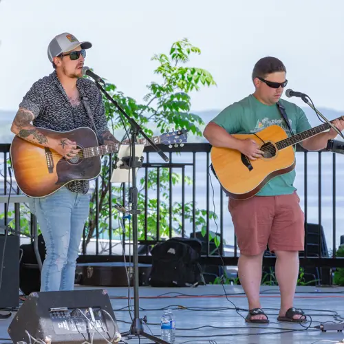 Two performers on stage playing music 